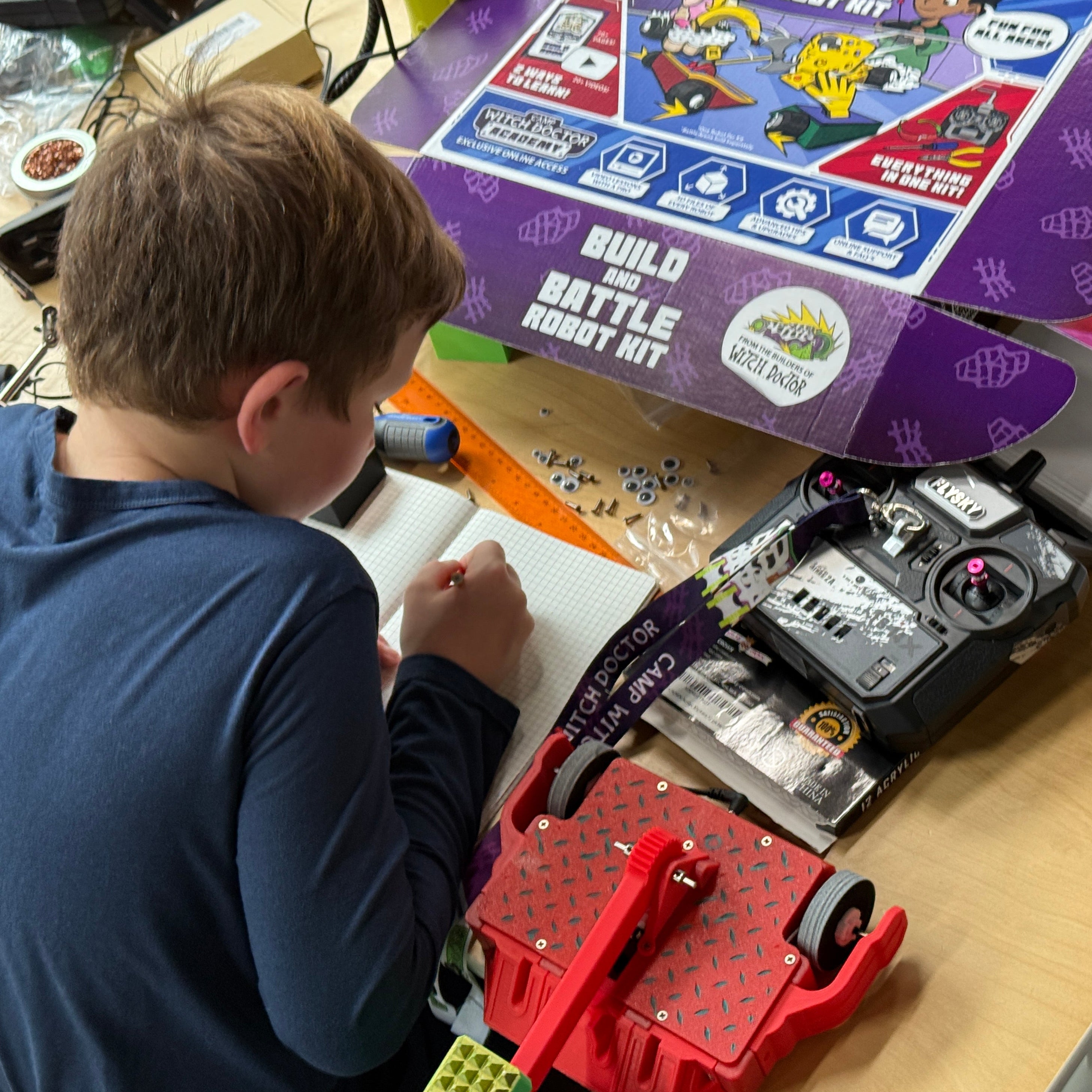 A boy works on building his RoboClash robot.